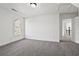 Bright bedroom featuring neutral walls, carpet, and a door leading to the upper level at 4050 Bonnett Creek Ln, Hoschton, GA 30548