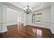 Chic dining area with hardwood floors, large windows, and classic chandelier, perfect for entertaining at 4050 Bonnett Creek Ln, Hoschton, GA 30548