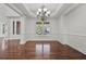 Elegant dining room with hardwood floors, detailed trim work, and large windows providing ample natural light at 4050 Bonnett Creek Ln, Hoschton, GA 30548