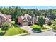 Beautiful two-story brick home with manicured lawn, mature trees, and a three-car garage at 4050 Bonnett Creek Ln, Hoschton, GA 30548