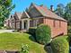 Charming brick home with a well-maintained lawn and lush landscaping at 4050 Bonnett Creek Ln, Hoschton, GA 30548