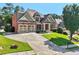 Attractive brick home with a spacious driveway and perfectly manicured front lawn at 4050 Bonnett Creek Ln, Hoschton, GA 30548