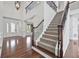 Grand foyer with hardwood floors, staircase, and elegant lighting fixtures at 4050 Bonnett Creek Ln, Hoschton, GA 30548