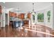 Well-lit kitchen with an island, stainless appliances, hardwood floors, and outdoor views at 4050 Bonnett Creek Ln, Hoschton, GA 30548