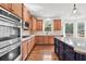 Modern kitchen with stainless steel appliances, granite countertops, and a functional center island at 4050 Bonnett Creek Ln, Hoschton, GA 30548