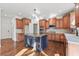 Open kitchen features an island, stainless steel appliances, and ample cabinet space for storage at 4050 Bonnett Creek Ln, Hoschton, GA 30548