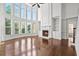 Inviting living room with a fireplace, built-in shelving, and large windows for natural light at 4050 Bonnett Creek Ln, Hoschton, GA 30548