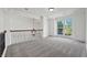 Loft space with natural lighting, carpet, and iron railing at 4050 Bonnett Creek Ln, Hoschton, GA 30548