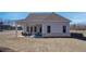 Expansive backyard features a covered patio with seating, perfect for outdoor entertaining at 7310 Winderlea Ln, Cumming, GA 30040