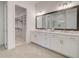 Bright bathroom with double vanity, modern fixtures, and walk-in closet access at 7310 Winderlea Ln, Cumming, GA 30040