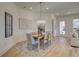 Dining room with chandelier, lots of natural light and an accent wall creates an elegant ambiance for gatherings at 7310 Winderlea Ln, Cumming, GA 30040