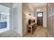 Charming entryway features light wood floors, decorative trim, and a view into the bathroom at 7310 Winderlea Ln, Cumming, GA 30040