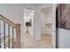 Hallway leading to the laundry room, featuring modern decor and bright lighting at 7310 Winderlea Ln, Cumming, GA 30040