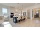 Bright kitchen features a center island with barstool seating, white cabinetry, and modern appliances at 7310 Winderlea Ln, Cumming, GA 30040