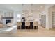 Bright and airy kitchen features a large island with seating, stainless steel appliances and open to the living area at 7310 Winderlea Ln, Cumming, GA 30040