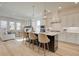 Elegant kitchen featuring white cabinets, an island with seating, and stainless steel appliances at 7310 Winderlea Ln, Cumming, GA 30040