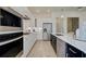 Modern kitchen featuring stainless steel appliances, white cabinetry, and an island with a sink at 7310 Winderlea Ln, Cumming, GA 30040