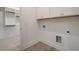 Bright laundry room featuring white cabinetry and modern washer/dryer hookups next to a walk-in closet at 7310 Winderlea Ln, Cumming, GA 30040