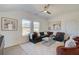 Cozy loft featuring a modern ceiling fan, bright windows, and a stylish sofa at 7310 Winderlea Ln, Cumming, GA 30040