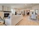 Open concept living room and kitchen with hardwood floors and a cozy fireplace at 7310 Winderlea Ln, Cumming, GA 30040