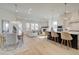 Open-concept kitchen and living space with island seating, dining area, and a fireplace for a cozy and inviting space at 7310 Winderlea Ln, Cumming, GA 30040