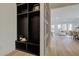 Modern mudroom with dark wood shelving, adjacent to a decorated living area at 7310 Winderlea Ln, Cumming, GA 30040