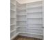Spacious walk-in closet with custom shelving offering ample storage and organization for the homeowner at 7310 Winderlea Ln, Cumming, GA 30040