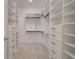 Well-organized walk-in closet with custom shelving and ample storage space for clothing and accessories at 7310 Winderlea Ln, Cumming, GA 30040