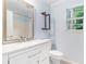 Bathroom featuring a modern vanity with granite countertop and wooden shelving at 112 Laguna Springs Dr, Woodstock, GA 30188