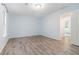 Relaxing bedroom with wood-look floors, a large window, and an open doorway, creating a seamless flow at 112 Laguna Springs Dr, Woodstock, GA 30188