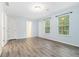 Charming bedroom with two windows, wood-look floors, and a neutral color palette, a tranquil haven at 112 Laguna Springs Dr, Woodstock, GA 30188