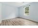 Inviting bedroom with natural light, wood-look floors, and neutral tones, creating a peaceful atmosphere at 112 Laguna Springs Dr, Woodstock, GA 30188