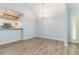 Spacious dining room featuring modern flooring, pendant lighting and kitchen bar at 112 Laguna Springs Dr, Woodstock, GA 30188