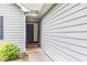 Home entryway featuring siding, sidewalk, and landscaping at 112 Laguna Springs Dr, Woodstock, GA 30188