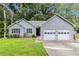Charming home featuring a well-maintained front yard, two-car garage, and classic curb appeal at 112 Laguna Springs Dr, Woodstock, GA 30188