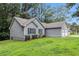 View of home, attached garage and well maintained lawn and landscaping at 112 Laguna Springs Dr, Woodstock, GA 30188