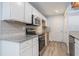 Updated kitchen boasts granite countertops, stainless steel appliances, and ample cabinet space at 112 Laguna Springs Dr, Woodstock, GA 30188