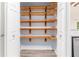 Pantry with wooden shelving and modern laminate flooring at 112 Laguna Springs Dr, Woodstock, GA 30188