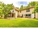 Well-maintained backyard with a covered patio and attached garage featuring a lush lawn at 130 Brooklet Way, Brooks, GA 30205