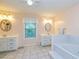 Well-lit bathroom boasting double vanity sinks, a jacuzzi tub, and tile flooring at 130 Brooklet Way, Brooks, GA 30205