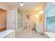 Comfortable bathroom featuring a single vanity, shower with curtain, and view from the window at 130 Brooklet Way, Brooks, GA 30205