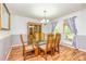 Bright dining room with wood floors, chandelier, and a glass-top table surrounded by wooden chairs at 130 Brooklet Way, Brooks, GA 30205