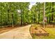 A private, tree-lined driveway leads to a gated entrance, enhancing the secluded feel at 130 Brooklet Way, Brooks, GA 30205