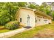 Single-story home with yellow siding, two garage doors, a side entrance, and landscaped yard at 130 Brooklet Way, Brooks, GA 30205