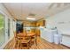 Combined kitchen and dining area offers a seamless flow for meal prep and enjoyment, featuring wood floors at 130 Brooklet Way, Brooks, GA 30205