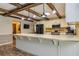 Open kitchen with breakfast bar, white cabinets, stainless steel appliances, and wood flooring at 130 Brooklet Way, Brooks, GA 30205