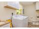 Functional laundry room with a washer, dryer, cabinets, and ample storage space at 130 Brooklet Way, Brooks, GA 30205