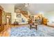A spacious living room features a vaulted ceiling, hardwood floors, and an open staircase at 130 Brooklet Way, Brooks, GA 30205