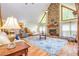 Spacious living room with a stone fireplace, vaulted ceiling, and hardwood floors at 130 Brooklet Way, Brooks, GA 30205