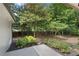 An outdoor patio leads to a spacious backyard with a combination of trees, shrubs, and landscaping at 4309 King Valley Se Dr, Smyrna, GA 30082